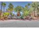 Neighborhood entrance adorned with mature palm trees and decorative rock features at 2723 Seabridge Dr, Las Vegas, NV 89121