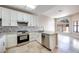Bright kitchen with stainless steel appliances, white cabinets, and a view to the backyard at 2723 Seabridge Dr, Las Vegas, NV 89121
