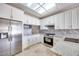 This modern kitchen features white cabinets, stainless steel appliances, and granite countertops at 2723 Seabridge Dr, Las Vegas, NV 89121