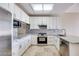 Modern kitchen with white cabinets, granite countertops, and stainless steel appliances at 2723 Seabridge Dr, Las Vegas, NV 89121
