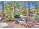 Lush landscaping surrounds this property with mature trees, shrubs, and a charming walkway at 2723 Seabridge Dr, Las Vegas, NV 89121