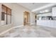 Open-concept living space with tile floors and a view into the kitchen and adjacent room at 2723 Seabridge Dr, Las Vegas, NV 89121
