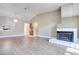 Spacious living room featuring wood flooring, fireplace, and modern light fixture at 2723 Seabridge Dr, Las Vegas, NV 89121