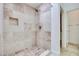 Neutral tile shower with built-in niche and handheld shower head at 2723 Seabridge Dr, Las Vegas, NV 89121