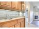 Charming living space featuring a wet bar with tile countertop and wood cabinetry at 2723 Seabridge Dr, Las Vegas, NV 89121