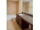 Bright bathroom features granite counters, and tile flooring and backsplash at 2831 Geary Pl # 2918, Las Vegas, NV 89109