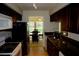 Efficient kitchen layout with dark cabinetry and access to the dining area at 2831 Geary Pl # 2918, Las Vegas, NV 89109