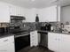 Modern kitchen featuring white cabinets, stainless steel appliances, and stylish backsplash at 2921 Country Manor Ln # 139, Las Vegas, NV 89115