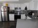 Bright kitchen with stainless steel refrigerator and appliances, complemented by white cabinetry at 2921 Country Manor Ln # 139, Las Vegas, NV 89115