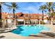 Community pool with lounge chairs and lush landscaping at 3111 Lido Isle Ct, Las Vegas, NV 89117