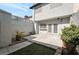Enclosed backyard featuring concrete patio, rose bushes, and rock landscaping at 3164 Richford Pl, Las Vegas, NV 89102