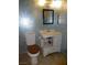 Bathroom with a sink, toilet, and decorative wallpaper at 3175 Palmdale St, Las Vegas, NV 89121