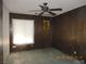 Bedroom with wood paneled walls, ceiling fan, and window at 3175 Palmdale St, Las Vegas, NV 89121