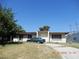 Single-story home with a flat roof, a small front porch, and a driveway at 3175 Palmdale St, Las Vegas, NV 89121