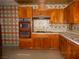 Kitchen with vintage appliances and wood cabinets at 3175 Palmdale St, Las Vegas, NV 89121