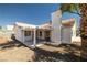 Spacious backyard featuring a covered patio, stucco wall, mature trees, and a desert landscape at 3414 Drescina Way, North Las Vegas, NV 89031