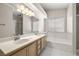 Bathroom featuring a double sink vanity, a soaking tub, and a glass enclosed shower at 3414 Drescina Way, North Las Vegas, NV 89031