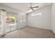 Bright bedroom featuring a ceiling fan, carpet, and a sliding glass door to the backyard at 3414 Drescina Way, North Las Vegas, NV 89031