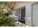 Close-up of the front entrance featuring a secure screen door and manicured landscaping on a sunny day at 3414 Drescina Way, North Las Vegas, NV 89031