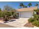 Inviting single-story home with well-maintained landscaping, a two-car garage, and mature landscaping at 3414 Drescina Way, North Las Vegas, NV 89031
