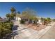 Quaint single-story home with desert landscaping, a tile roof, and secure front yard fencing for privacy at 3414 Drescina Way, North Las Vegas, NV 89031