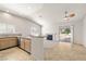 Open kitchen featuring tile flooring, modern appliances, and a breakfast bar overlooking a fireplace at 3414 Drescina Way, North Las Vegas, NV 89031