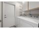 Functional laundry room with washer, dryer, shelving, and storage at 3414 Drescina Way, North Las Vegas, NV 89031