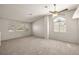 Bright living room with carpet, vaulted ceilings, ceiling fan, and ample natural light from large windows at 3414 Drescina Way, North Las Vegas, NV 89031