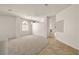 Spacious living room with neutral carpet, tile entryway, and a view of the bright, open floor plan at 3414 Drescina Way, North Las Vegas, NV 89031