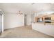 Open-concept living room with stainless steel appliances and a sliding glass door to the backyard at 3414 Drescina Way, North Las Vegas, NV 89031