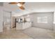 Open-concept living room with stainless steel appliances, granite counters, and a ceiling fan at 3414 Drescina Way, North Las Vegas, NV 89031