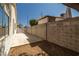 Side yard featuring a tall brick wall, stucco siding, and concrete slab at 3414 Drescina Way, North Las Vegas, NV 89031