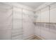 Bright walk-in closet with white shelving system, offering ample storage and organization at 3414 Drescina Way, North Las Vegas, NV 89031