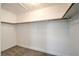 Walk-in closet featuring neutral carpet and wood railing at 370 Manti Pl # 21, Henderson, NV 89014