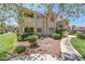 A charming apartment complex featuring lush landscaping and desert accents at 370 Manti Pl # 21, Henderson, NV 89014