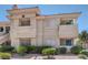 Exterior shot of the building featuring multiple balconies, windows, and landscape at 370 Manti Pl # 21, Henderson, NV 89014