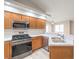 This kitchen is equipped with stainless steel appliances and natural wood cabinets at 370 Manti Pl # 21, Henderson, NV 89014