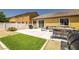 Great backyard featuring concrete patio, green turf, and desert landscaping for minimal maintenance at 3773 Blake Canyon Dr, North Las Vegas, NV 89032