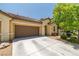 Charming single-story home featuring a well-maintained lawn and a two-car garage on a sunny day at 3773 Blake Canyon Dr, North Las Vegas, NV 89032