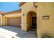 Close-up of a home's entrance, showcasing a well-maintained facade and a convenient two-car garage at 3773 Blake Canyon Dr, North Las Vegas, NV 89032