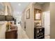 Bright hallway with tile flooring, connecting various rooms and decorated with tasteful artwork and furniture at 3773 Blake Canyon Dr, North Las Vegas, NV 89032