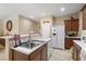Bright kitchen with white appliances, wood cabinets, stainless steel sink, and neutral countertops at 3773 Blake Canyon Dr, North Las Vegas, NV 89032