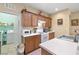 Cozy kitchen features wooden cabinets, white appliances and laundry room access at 3773 Blake Canyon Dr, North Las Vegas, NV 89032