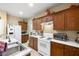 Cozy kitchen with wood cabinets, white appliances, and white countertop with a stainless steel sink at 3773 Blake Canyon Dr, North Las Vegas, NV 89032