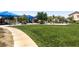 A well-manicured park boasts a lush lawn, meandering pathways, and mature trees at 3773 Blake Canyon Dr, North Las Vegas, NV 89032