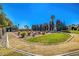 Landscaped community garden featuring a circular layout, desert landscaping, and mature trees at 4036 Nightingale Ct, Las Vegas, NV 89107