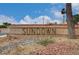 Sundown community entrance sign, featuring desert landscaping, a brick base, and clear blue skies at 4036 Nightingale Ct, Las Vegas, NV 89107