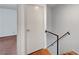 Hallway with a white door, a stairway with black railings, and access to other rooms at 4036 Nightingale Ct, Las Vegas, NV 89107