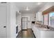 Modern kitchen featuring white cabinetry, stainless steel appliances, and a washer/dryer combo at 4036 Nightingale Ct, Las Vegas, NV 89107