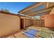 Private outdoor patio with slat roof and access to outside of home at 4036 Nightingale Ct, Las Vegas, NV 89107